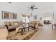 Elegant living room featuring a neutral color palette, tile flooring, and an abundance of natural light at 44250 W Vineyard St, Maricopa, AZ 85139