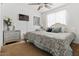 Comfortable main bedroom with a ceiling fan, carpet, and ample natural light from the window at 44250 W Vineyard St, Maricopa, AZ 85139