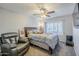 Comfortable bedroom with a plush armchair, a well-made bed and a window with shutters at 5507 E Grandview Rd, Scottsdale, AZ 85254