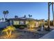 Beautifully landscaped home exterior with mature trees and manicured bushes providing enhanced curb appeal with ample parking at 5507 E Grandview Rd, Scottsdale, AZ 85254