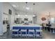 Bright open kitchen with stainless appliances, white cabinetry, pendant lights and large island with seating at 5507 E Grandview Rd, Scottsdale, AZ 85254