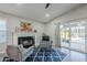 Cozy living room with a fireplace, modern furniture, and access to the outdoor patio at 5507 E Grandview Rd, Scottsdale, AZ 85254