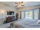 Comfortable main bedroom with backyard views, a TV, and dark wood furniture at 5507 E Grandview Rd, Scottsdale, AZ 85254