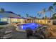 Inviting backyard pool featuring rock waterfall and spa, set against a backdrop of palm trees at 5507 E Grandview Rd, Scottsdale, AZ 85254