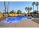 Stunning backyard pool with a waterfall feature, lush landscaping, and ambient lighting, creating a serene oasis at 5507 E Grandview Rd, Scottsdale, AZ 85254