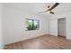 Bright bedroom with wood flooring, a ceiling fan, and a closet at 5719 E Sweetwater Ave, Scottsdale, AZ 85254