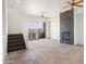 Living room with fireplace, balcony access, and tile floors at 6745 N 93Rd Ave # 1138, Glendale, AZ 85305