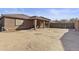 Spacious dirt backyard featuring a covered patio, perfect for outdoor activities and landscaping at 676 N 156Th Ln, Goodyear, AZ 85338