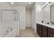 Modern bathroom with a soaking tub, glass-enclosed shower, and a vanity with dark cabinets at 676 N 156Th Ln, Goodyear, AZ 85338