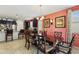 Inviting dining room with elegant dark wood table set and complementary dark wood kitchen cabinets at 676 N 156Th Ln, Goodyear, AZ 85338