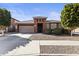 Charming single-story home featuring stone accents, a two-car garage, and manicured landscaping at 676 N 156Th Ln, Goodyear, AZ 85338