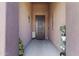 Inviting front entryway featuring a secure iron gate, decorative elements, and shaded porch at 676 N 156Th Ln, Goodyear, AZ 85338