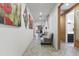 Inviting hallway with neutral paint, tile flooring, recessed lighting and decorative art pieces at 676 N 156Th Ln, Goodyear, AZ 85338