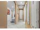 Hallway featuring decorative art and leading to a living room with a comfortable armchair at 676 N 156Th Ln, Goodyear, AZ 85338