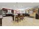Spacious open floor plan featuring kitchen with granite countertops, dark wood cabinets, and an island with bar seating at 676 N 156Th Ln, Goodyear, AZ 85338