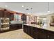 Bright kitchen with dark cabinetry, stainless steel appliances, and a large island at 676 N 156Th Ln, Goodyear, AZ 85338