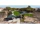 Community playground featuring covered picnic area, modern play structure, swings and expansive green space at 676 N 156Th Ln, Goodyear, AZ 85338