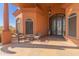 Covered entryway with ornate double doors and comfortable seating area at 8540 E Mcdowell Rd # 55, Mesa, AZ 85207