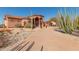 Pathway to home features gravel and desert plants, leading to the entrance at 8540 E Mcdowell Rd # 55, Mesa, AZ 85207