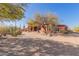 Driveway leads to a beautiful Southwestern style home with mature trees at 8540 E Mcdowell Rd # 55, Mesa, AZ 85207