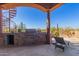 Outdoor kitchen with stone countertops and built-in grill at 8540 E Mcdowell Rd # 55, Mesa, AZ 85207
