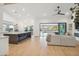 Spacious living room combines a neutral sofa with a modern kitchen and outdoor pool view at 8900 E Palm Tree Dr, Scottsdale, AZ 85255