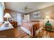 Comfortable bedroom features wood-look floors, a ceiling fan, and neutral wall color at 10407 N 108Th Ave, Sun City, AZ 85351