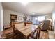 Cozy dining area with a rustic wooden table, chairs, and seamlessly connected to the inviting living room at 10407 N 108Th Ave, Sun City, AZ 85351