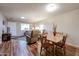 Cozy dining area with a rustic wooden table, chairs, seamlessly connected to the inviting living room at 10407 N 108Th Ave, Sun City, AZ 85351