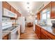 Spacious kitchen featuring wood cabinets and countertops, with seamless connection to the adjacent dining space at 10407 N 108Th Ave, Sun City, AZ 85351