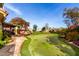 Landscaped backyard oasis with putting green, patio furniture, and covered seating area at 10425 N 23Rd St, Phoenix, AZ 85028