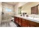 Double vanity bathroom with glass shower and modern fixtures at 10425 N 23Rd St, Phoenix, AZ 85028