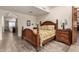 Main bedroom with wooden bed frame, and access to bathroom at 10425 N 23Rd St, Phoenix, AZ 85028