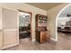 Entryway with wood floors, antique cabinet, and view into living area at 10425 N 23Rd St, Phoenix, AZ 85028