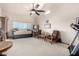 Bright sitting room with daybed, seating area, and ceiling fan at 10425 N 23Rd St, Phoenix, AZ 85028