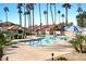 Community pool with lounge chairs and umbrellas at 11515 N 91 St # 238, Scottsdale, AZ 85260