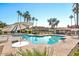 Community pool with lounge chairs and umbrellas at 11515 N 91 St # 238, Scottsdale, AZ 85260