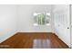 Light and airy bedroom featuring hardwood floors and double doors at 11722 E Starflower Dr, Chandler, AZ 85249