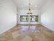 Bright dining room with tile floors and chandelier, offering pool views at 11722 E Starflower Dr, Chandler, AZ 85249