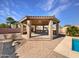 Outdoor kitchen and dining area under covered pergola at 11722 E Starflower Dr, Chandler, AZ 85249