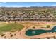 Wide aerial view of community, golf course, and lake at 1179 E Coyote Creek Way, San Tan Valley, AZ 85143