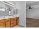 Double vanity bathroom with wood cabinets and view of bedroom at 1179 E Coyote Creek Way, San Tan Valley, AZ 85143