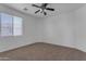 Bright bedroom with window and ceiling fan at 1179 E Coyote Creek Way, San Tan Valley, AZ 85143