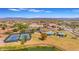 Aerial view of community amenities: tennis courts, pool, and pond at 1179 E Coyote Creek Way, San Tan Valley, AZ 85143