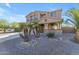 Two-story house with a three-car garage and desert landscaping at 1179 E Coyote Creek Way, San Tan Valley, AZ 85143