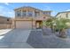 Two-story house with a three-car garage and desert landscaping at 1179 E Coyote Creek Way, San Tan Valley, AZ 85143