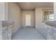 Front entry with a white door and stone pillars at 1179 E Coyote Creek Way, San Tan Valley, AZ 85143