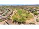 Aerial view of a green golf course with residential homes surrounding at 1179 E Coyote Creek Way, San Tan Valley, AZ 85143