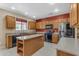 Modern kitchen featuring a large island, wood cabinets, and stainless steel appliances at 1179 E Coyote Creek Way, San Tan Valley, AZ 85143