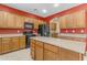 Modern kitchen with an island, wood cabinets, and stainless steel appliances at 1179 E Coyote Creek Way, San Tan Valley, AZ 85143